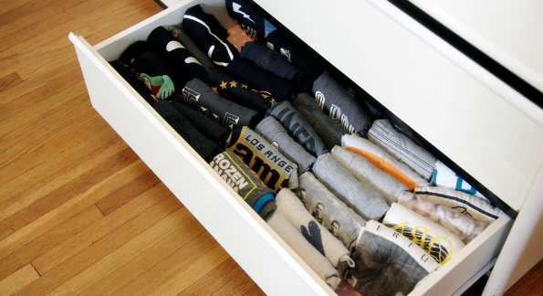 A drawer of shirts neatly folded according to the KonMari method.